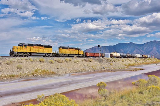 If made law, under House Bill HR 3651 trains carrying passengers and or certain hazardous materials will be able to operate as is as the current PTC deadline is extended from Decmber 31st 2015 to December 31st 2018. Here a Union Pacific freight train operates near the Great Salt Lake in Utah.  (image © 9/2015 Nikki Burgess; all rights reserved) 
